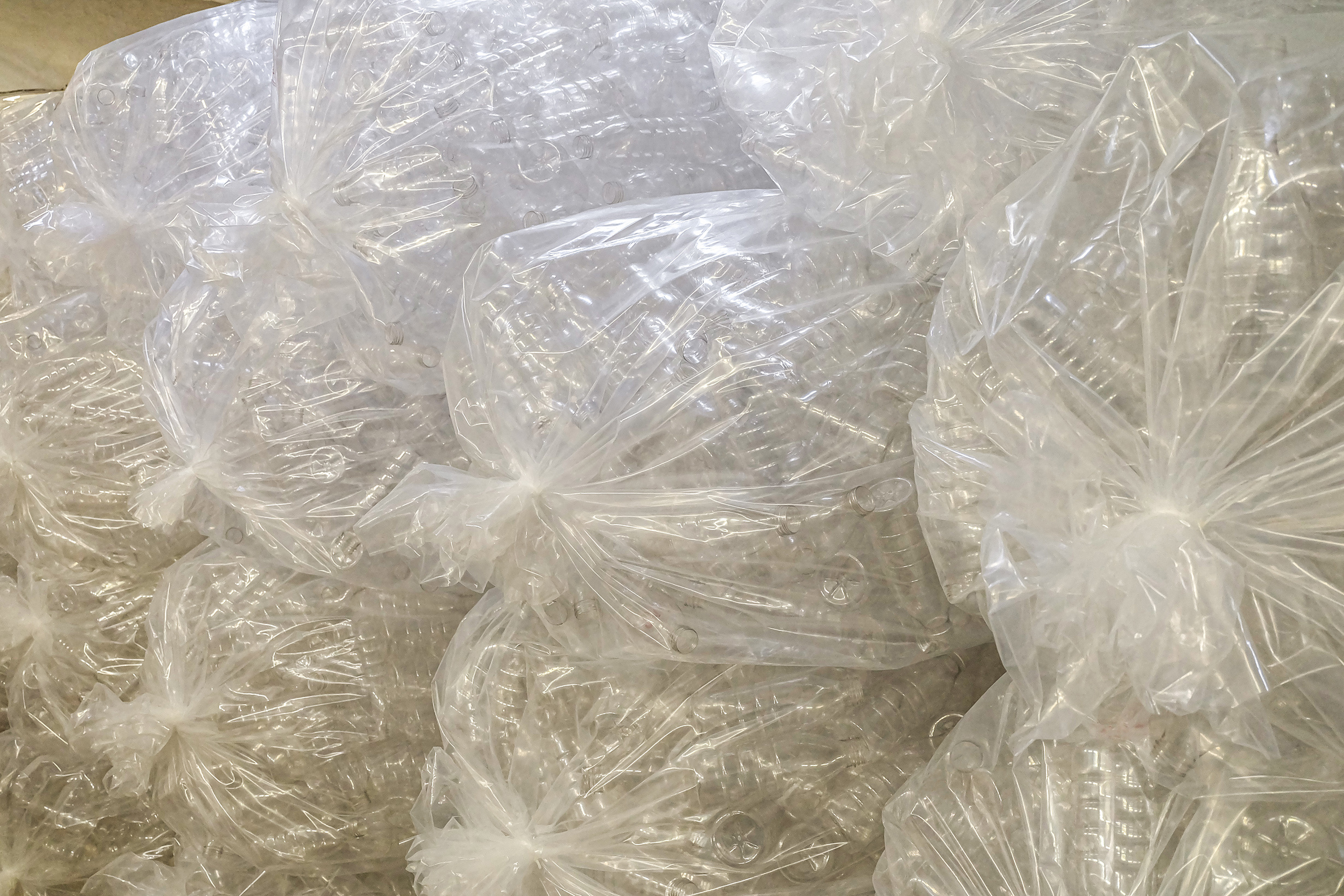 Empty plastic bottles for filling food products in plastic packaging. Clean bottles for milk and yoghurt in production.