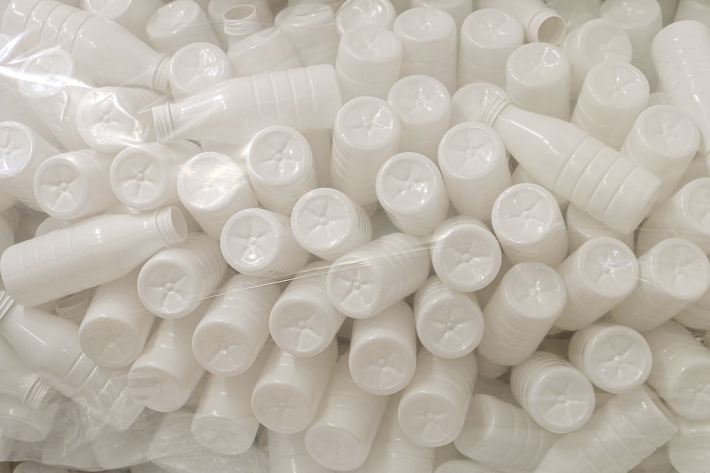 Empty plastic bottles for filling food products in plastic packaging. Clean bottles for milk and yoghurt in production.